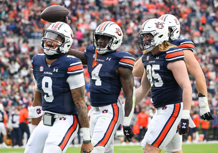 Tyler Fromm (85),Robby Ashford (9),and Tank Bigsby (4) celebrate a touchdownduring the football game between the Western Kentucky Hilltoppers and the Auburn Tigers at Jordan Hare Stadium in Auburn, AL on Saturday, Nov 19, 2022. Todd Van Emst/Auburn Tigers